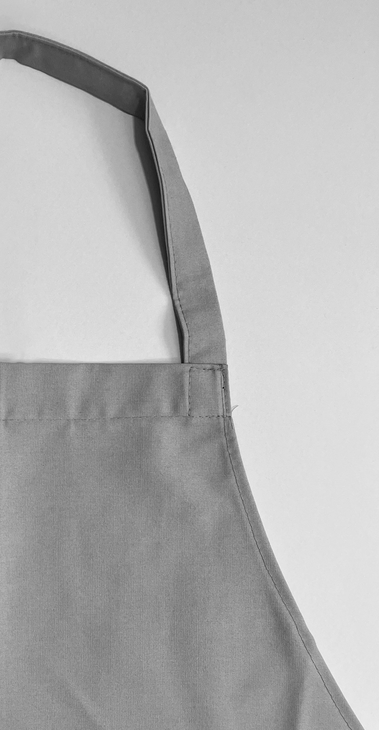 Pechera Carpintero unisex gris claro con bolsillo escocés